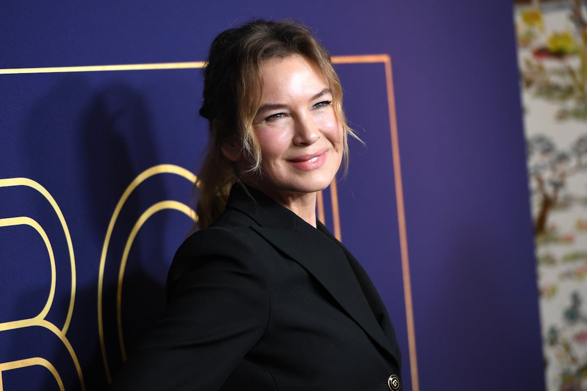 Renée Zellweger smiles and poses at an event.