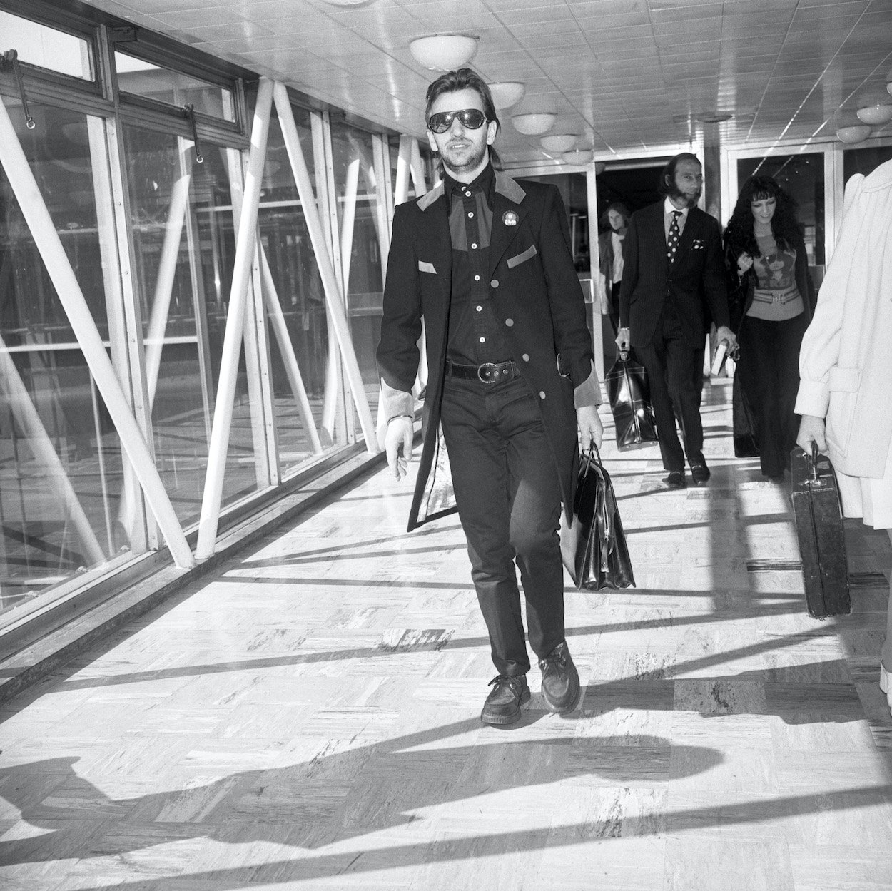 Ringo Starr carries a bag while walking through Heathrow Airport in London in 1972.