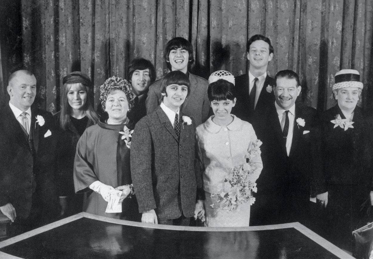 Ringo Starr (front center left) and Maureen Cox (front center right) flanked by family, John and Cynthia Lennon, George Harrison, and Beatles manager Brian Epstein.