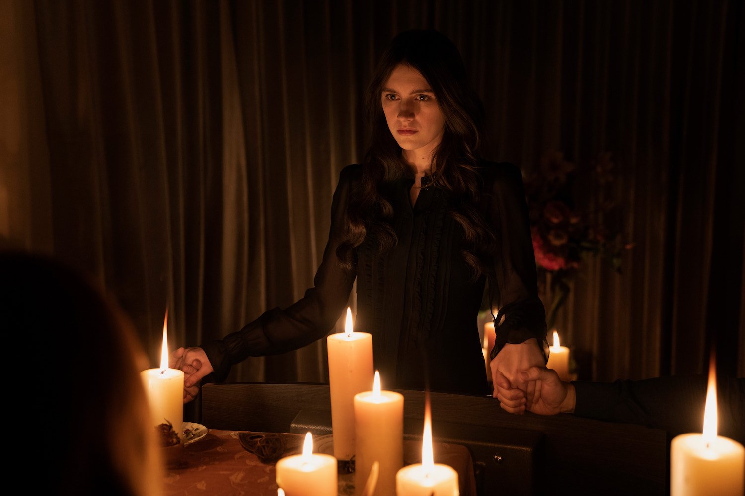 'Servant' episode 'Séance' features Nell Tiger Free as Leanne, seen here in a black dress, surrounded by candles.