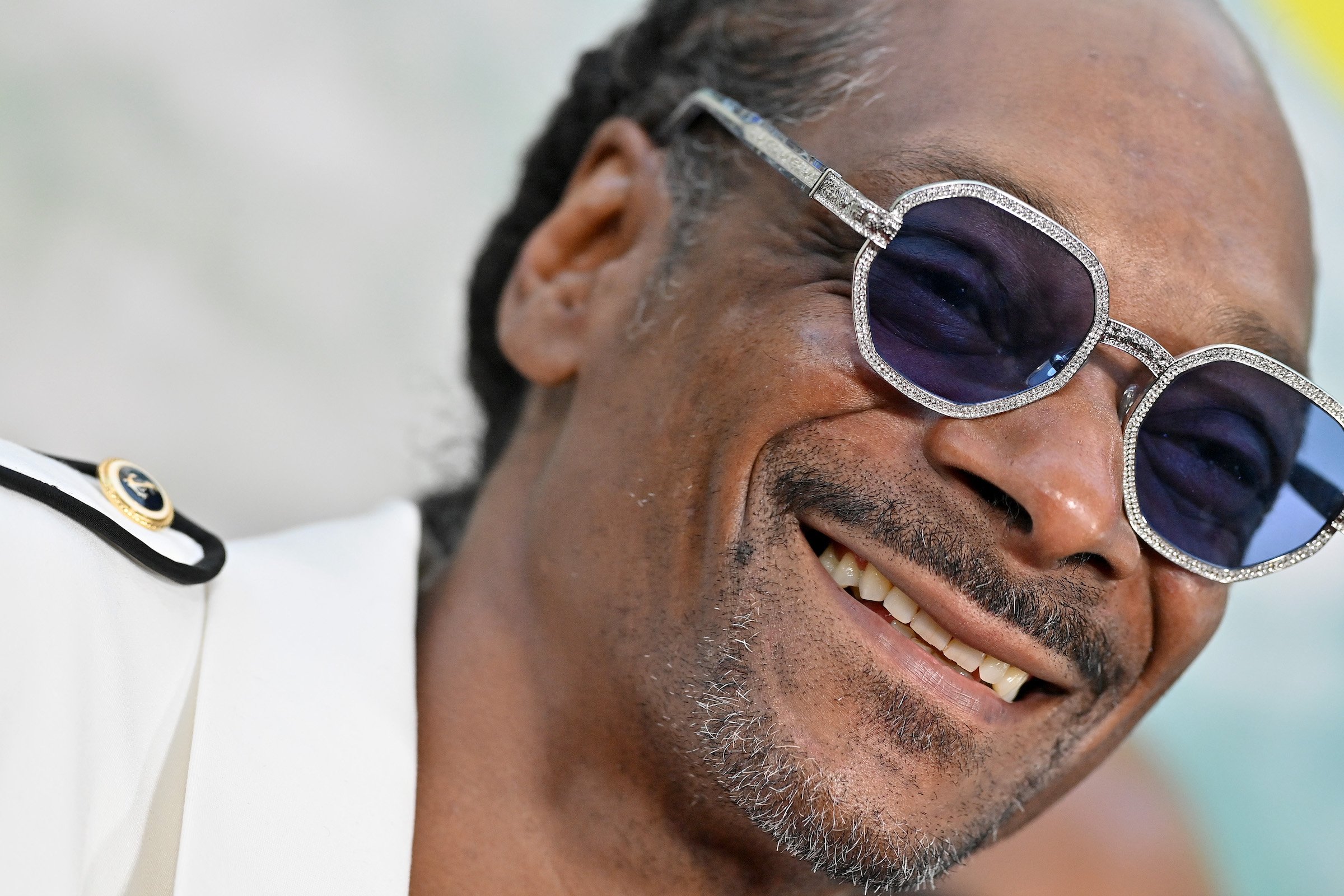 Snoop Dogg, who admitted he was 'out-gangstered' by Dionne Warwick, smiling for a photo