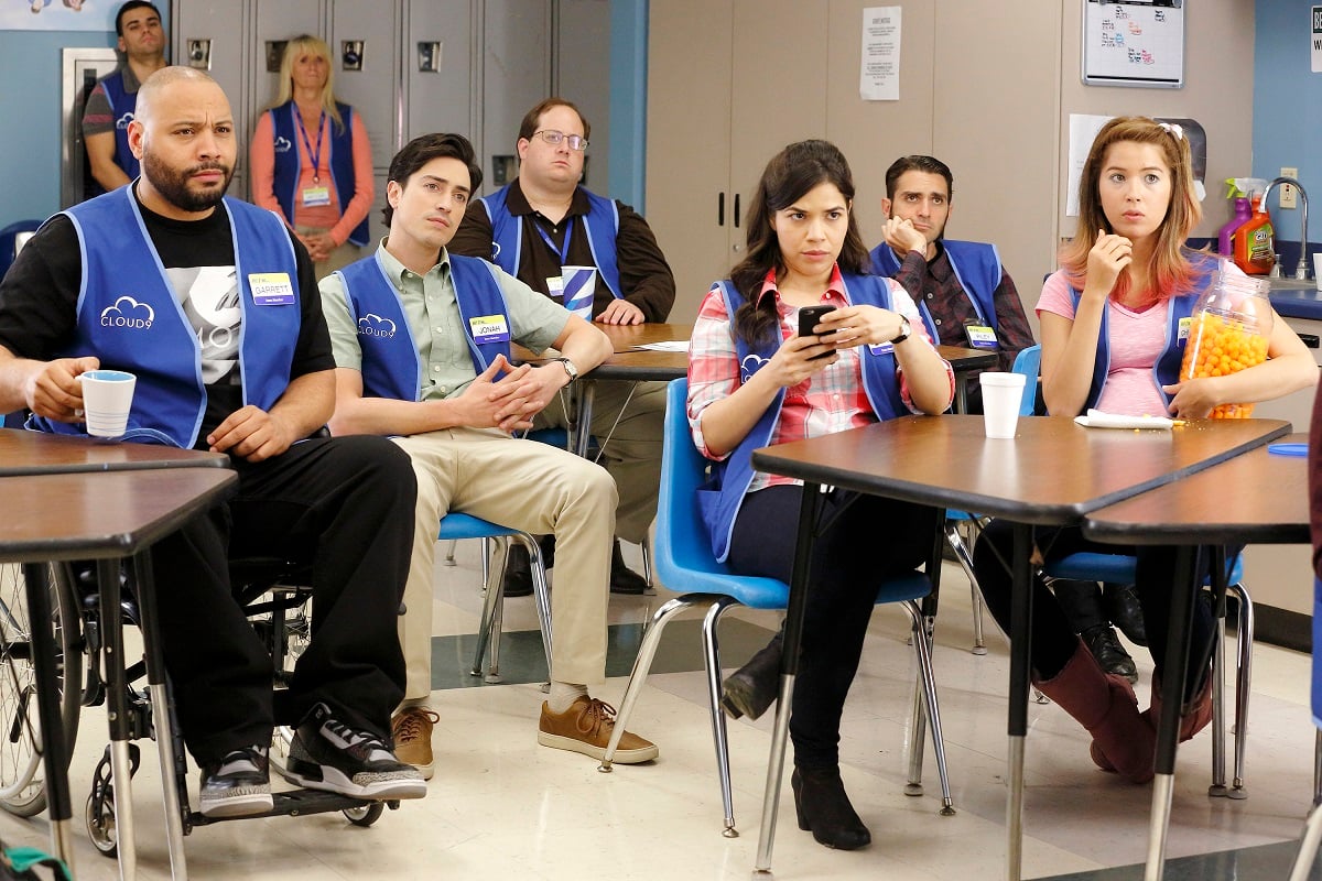 The cast of 'Superstore' sit in the break room during one of Glen's company meetings.