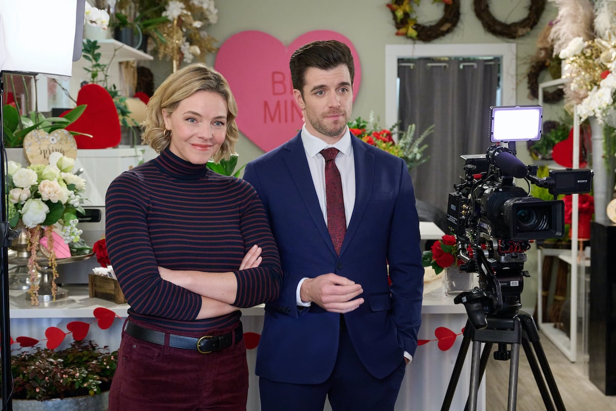 Eloise Mumford standing next to Dan Jeannotte in 'Sweeter Than Chocolate,' one of several new romance movies airing on Hallmark in February 2023