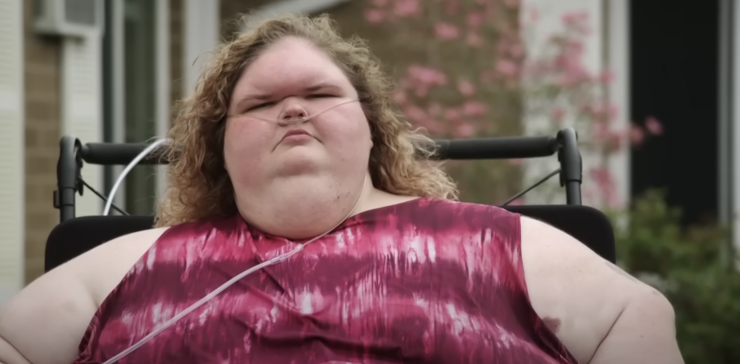 Tammy Slaton from '1000-Lb. Sisters' Season 4 sitting outside in a wheelchair wearing a pink dress