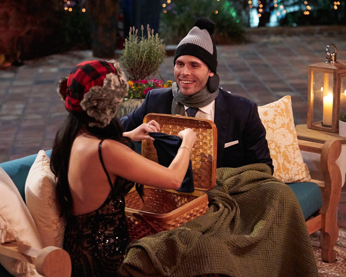 During night one of The Bachelor 2023, Madison dresses Zach Shallcross in winter gear. 