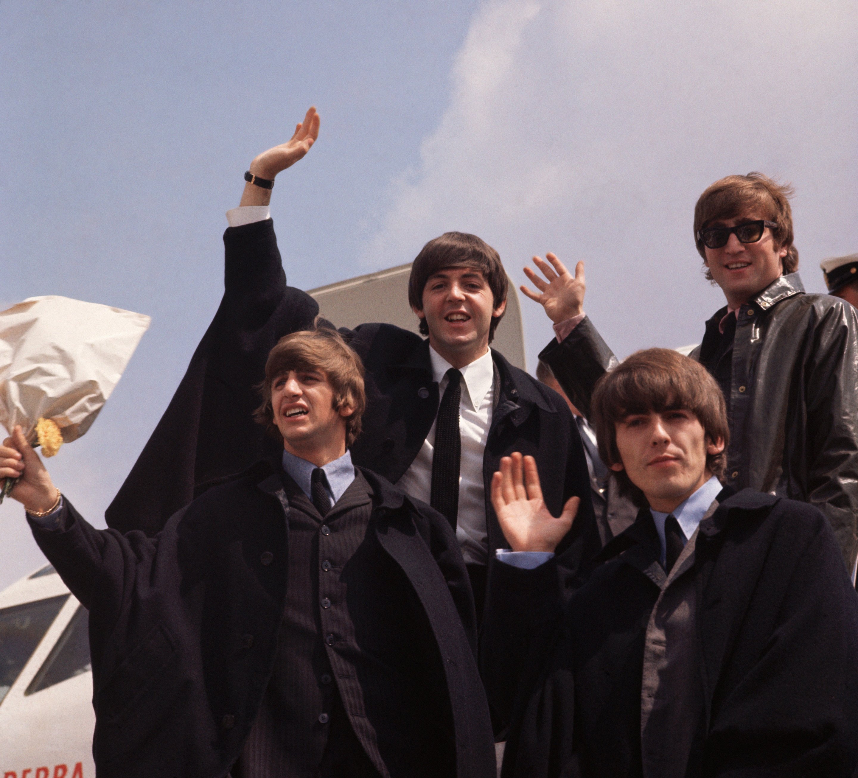 The Beatles, John Lennon, George Harrison, Paul McCartney, and Ringo Starr, pictured on their arrival in London following a tour