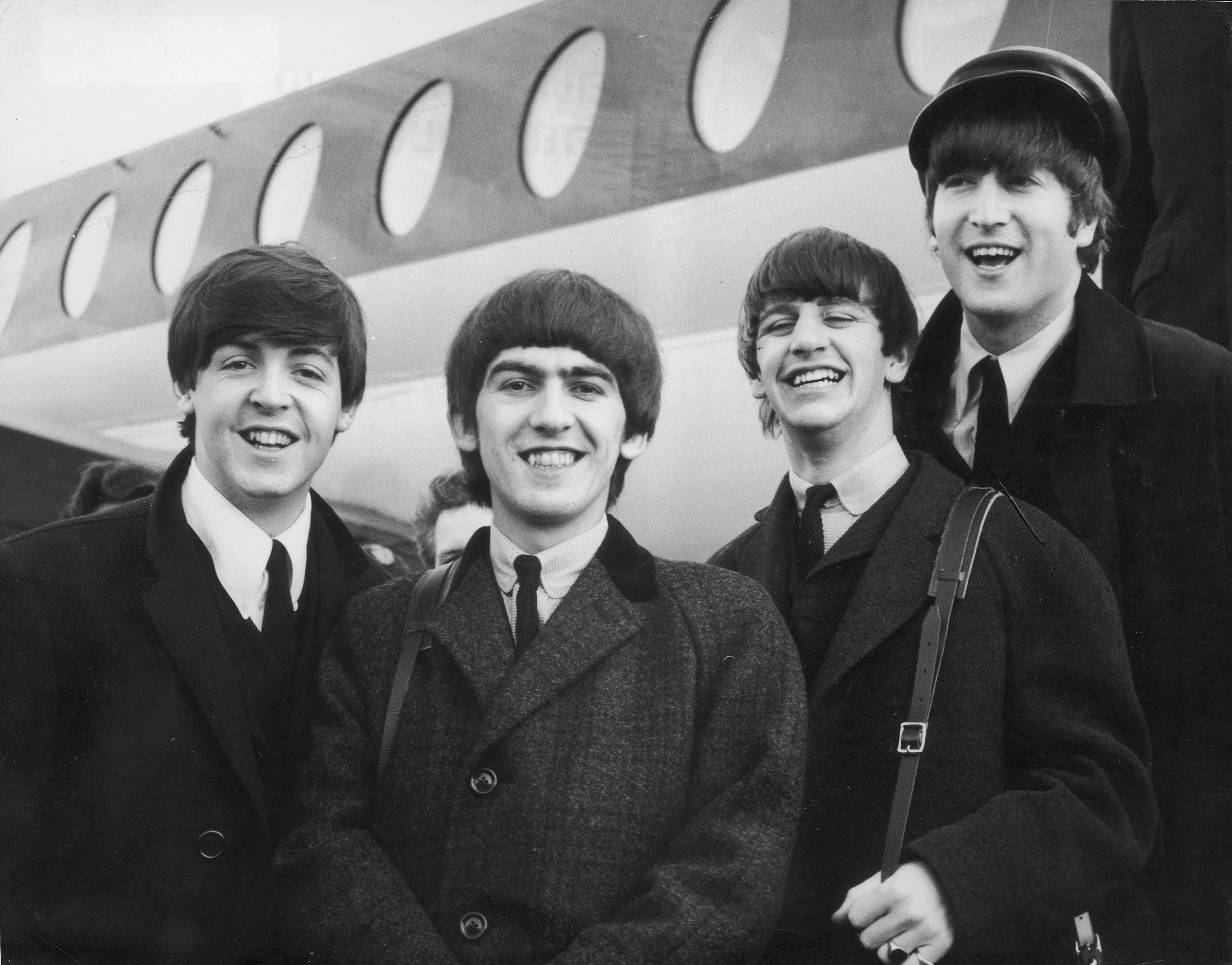 The Beatles, left to right, Paul McCartney, George Harrison, Ringo Starr, and John Lennon arrive at London Airport