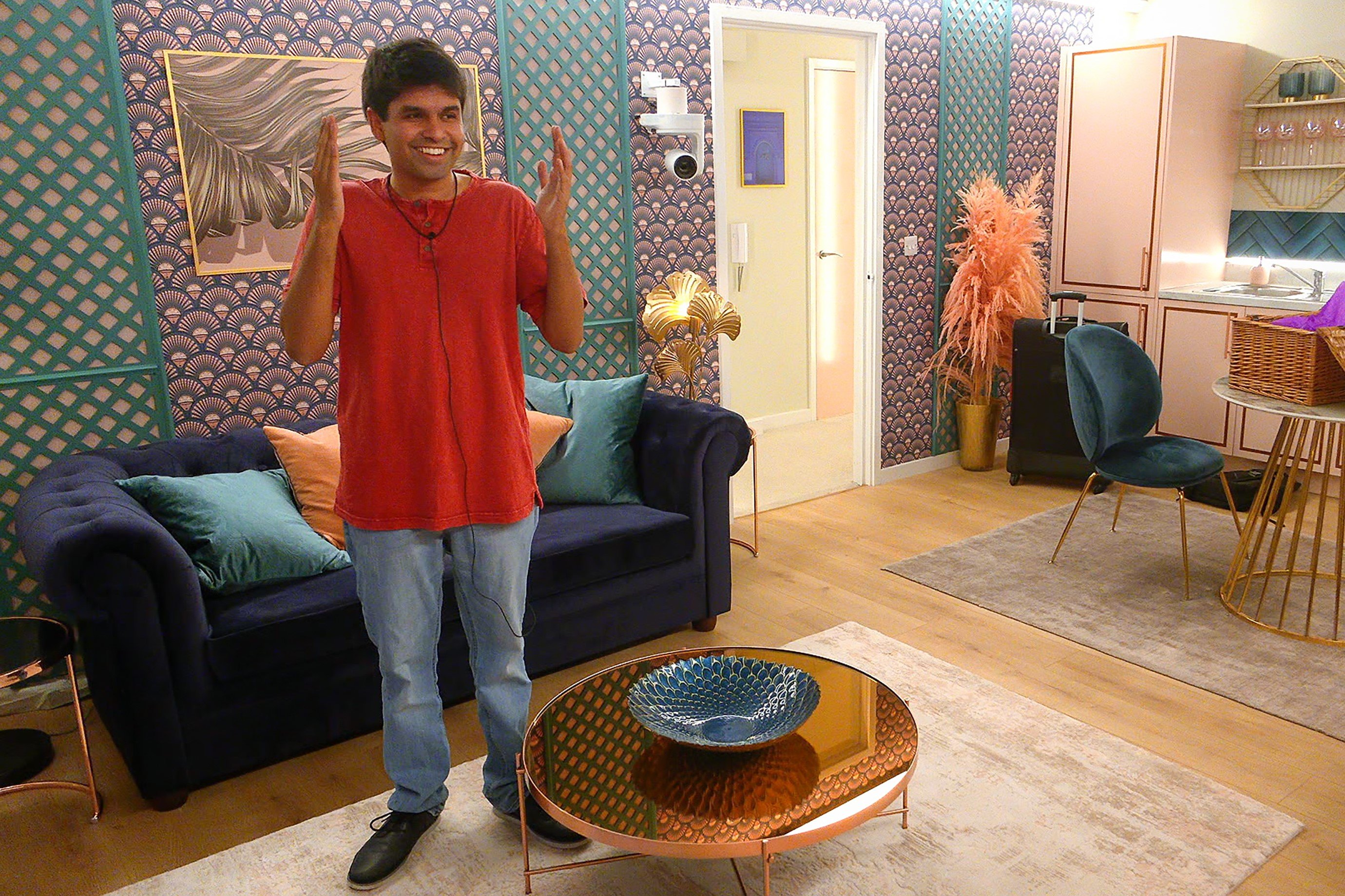 Shubham Goel, who came in second place in 'The Circle' Season 1, wears a red shirt and jeans.