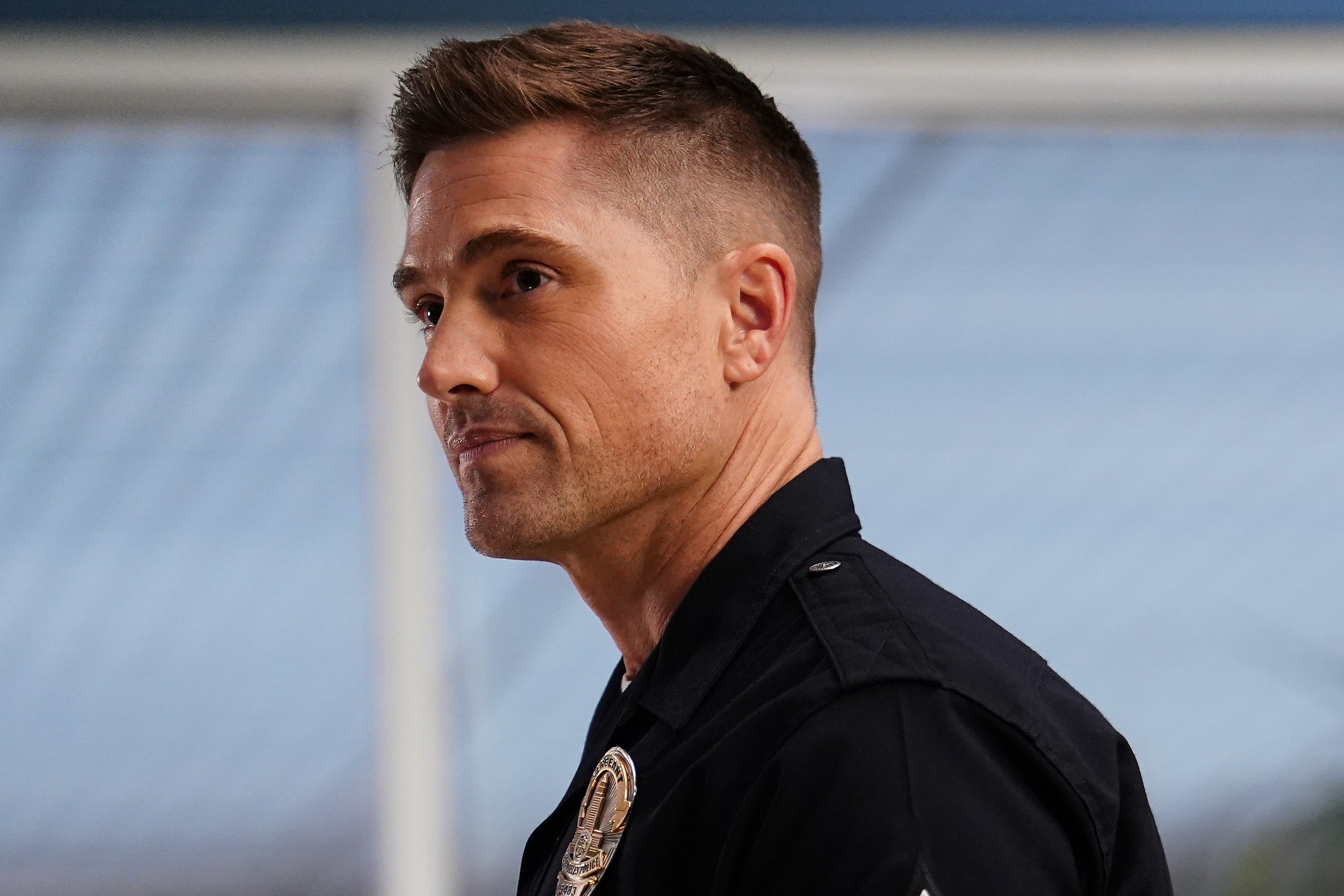 Eric Winter, in character as Tim Bradford in 'The Rookie' Season 5 Episode 13, wears his black police uniform.