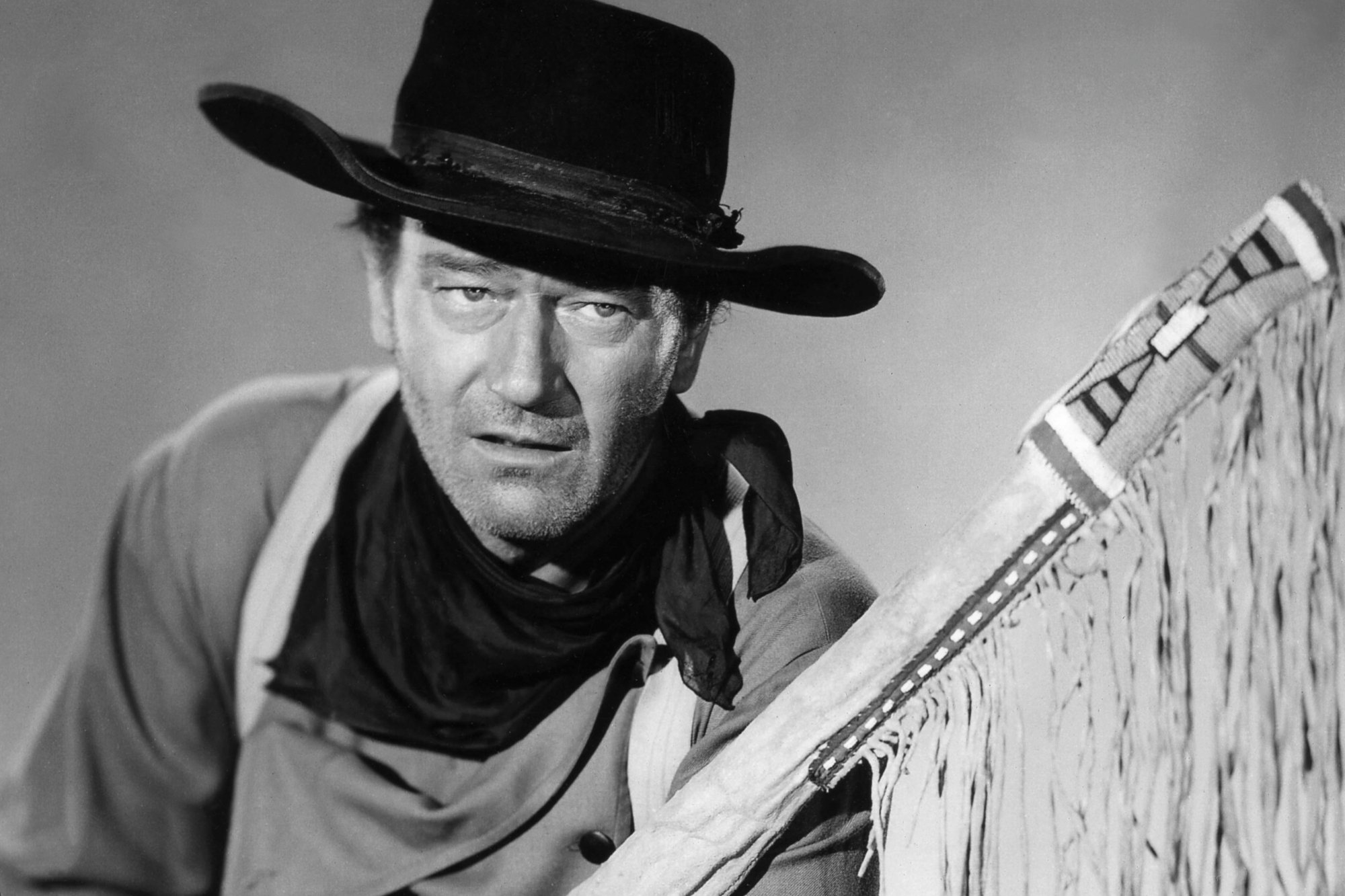 'The Searchers' John Wayne as Ethan Edwards, whose performance Clint Eastwood called 'brilliant' in a black-and-white photo wearing a Western costume