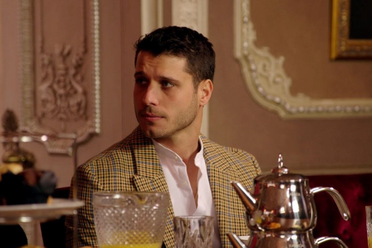 Cody Calafiore, who starred in 'The Traitors' on Peacock, wears a yellow and gray plaid suit over a white button-up shirt.