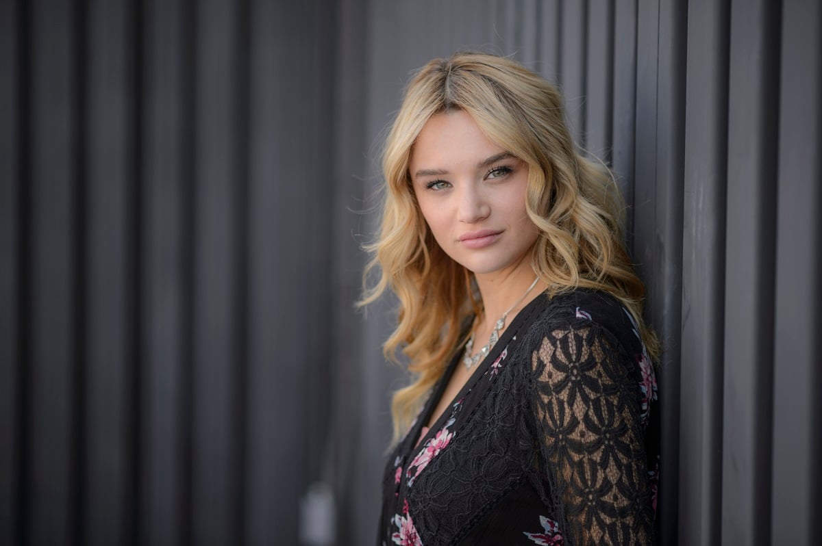 'The Young and the Restless' star Hunter King in a black dress; poses against a wall.