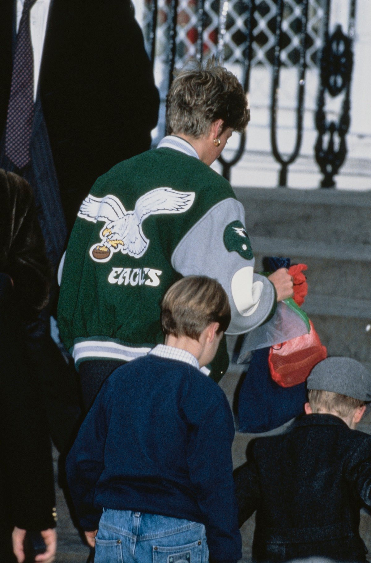 The back of Princess Diana's Philadelphia Eagles jacket bearing the team's logo as she drops Prince Harry off