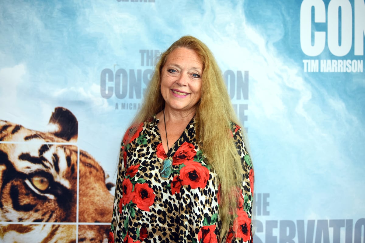 Tiger King star Carole Baskin attends the Los Angeles theatrical premiere of The Conservation Game wearing a leopord-print dress with flowers on it.