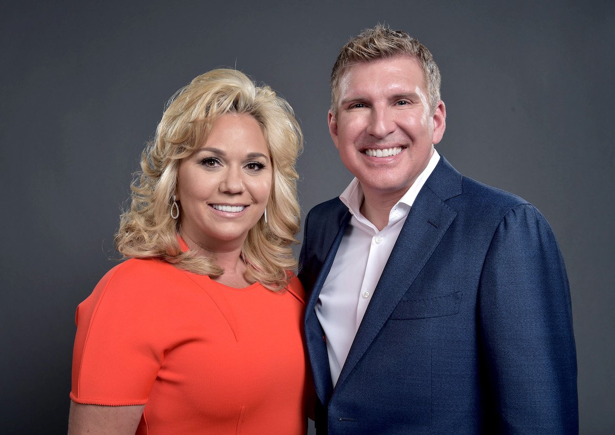 "Chrisley Knows Best" stars Julie and Todd Chrisley smile and pose together for a portrait.