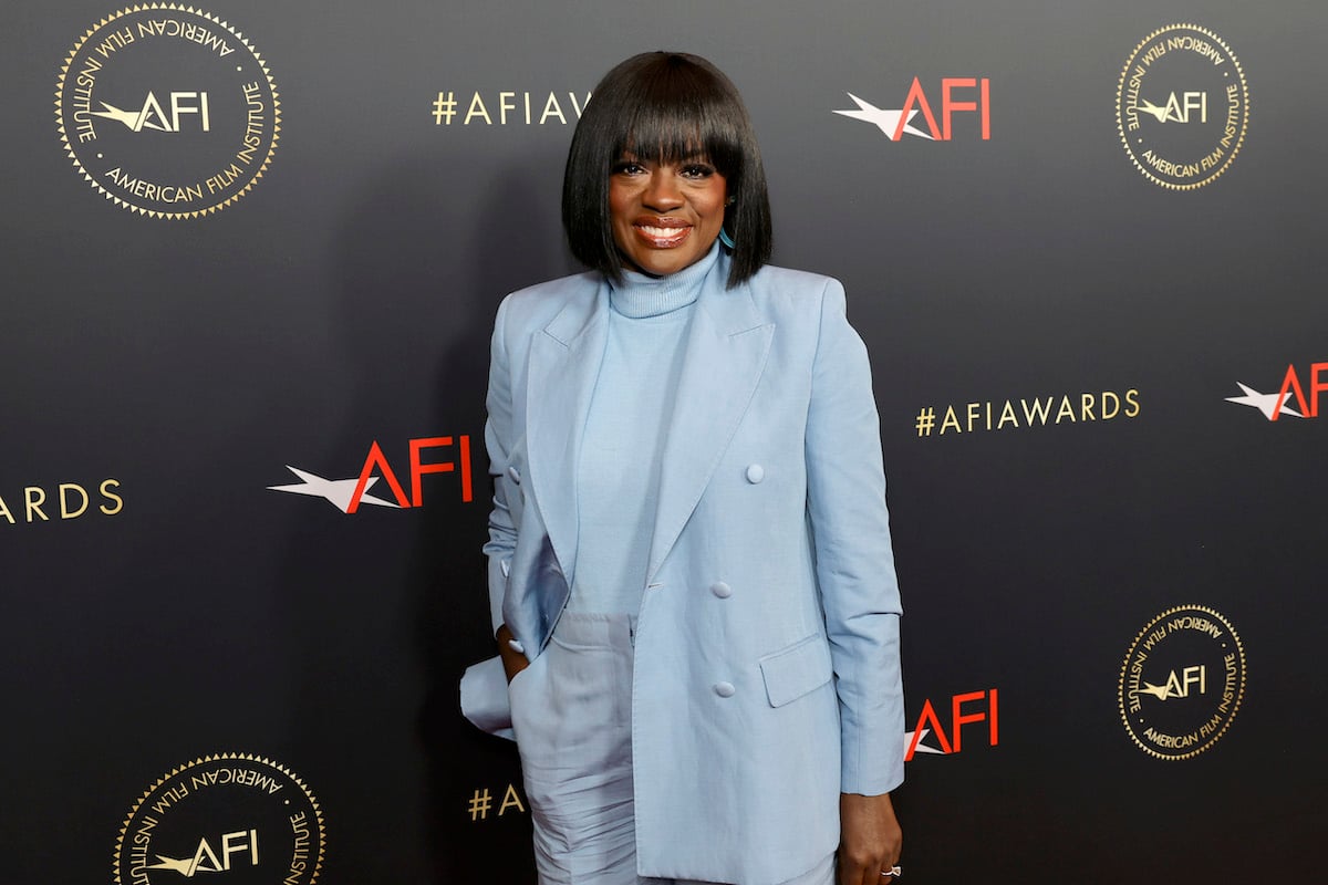 Viola Davis poses in front of a backdrop featuring the AFI logo