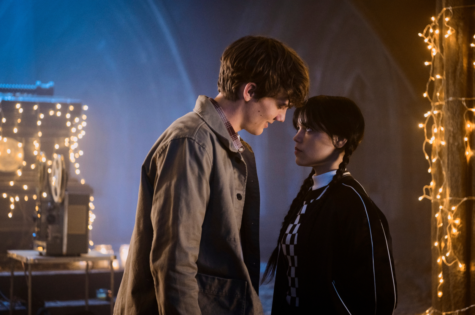 Hunter Doohan and Jenna Ortega in 'Wednesday,' which has been renewed for season 2. The two are looking at one another and about to kiss.