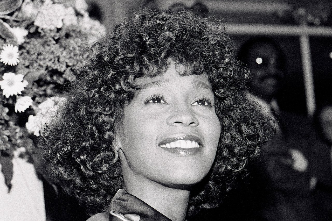 Whitney Houston smiles in candid black and white photo