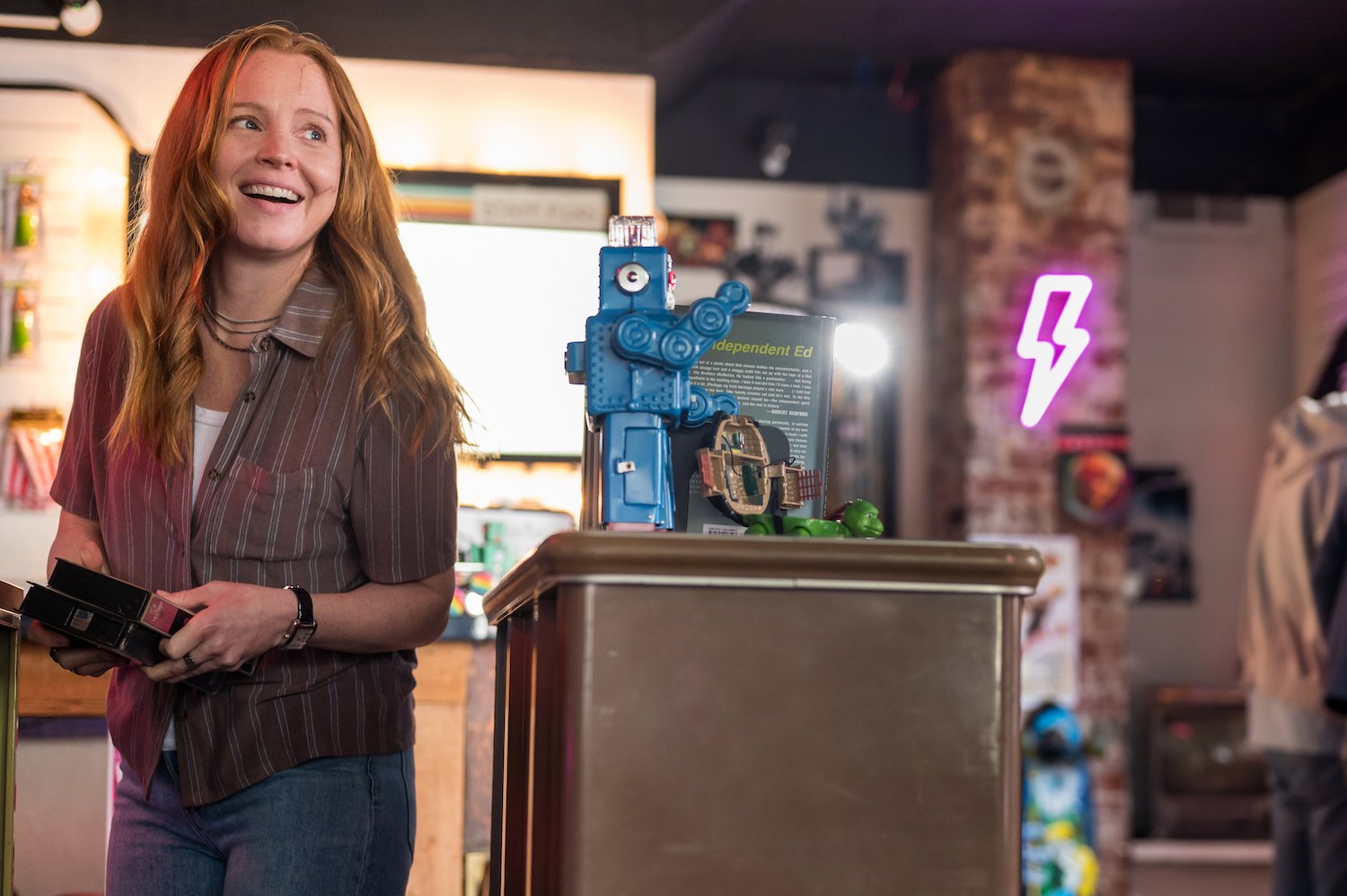 Lauren Ambrose, seen here playing the adult version of Van Palmer wearing a striped button down shirt, joins the cast of 'Yellowjackets' Season 2.