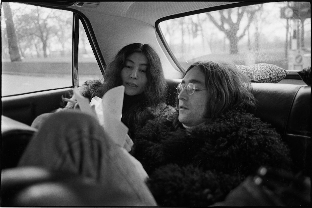 Yoko Ono (left) and Beatles songwriter, guitarist, and singer John Lennon in the back of a car in December 1968.