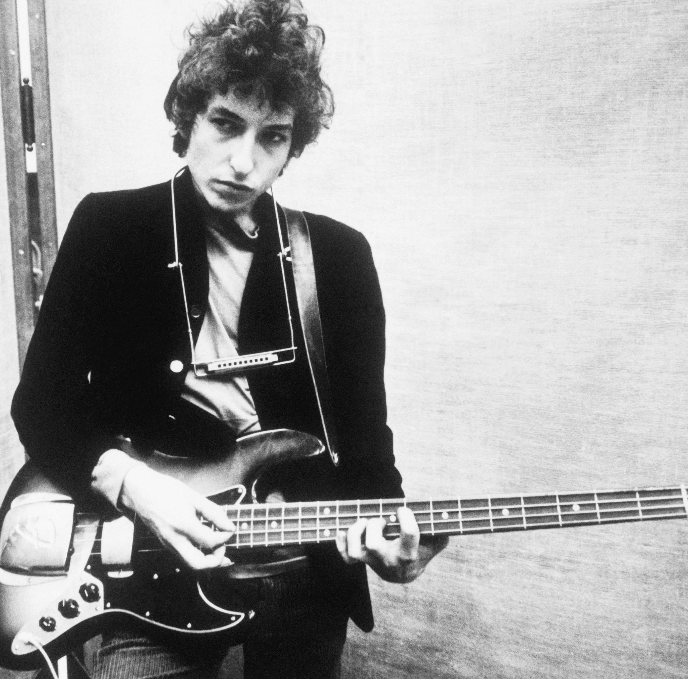 "A Hard Rain's a-Gonna Fall" singer Bob Dylan with a guitar