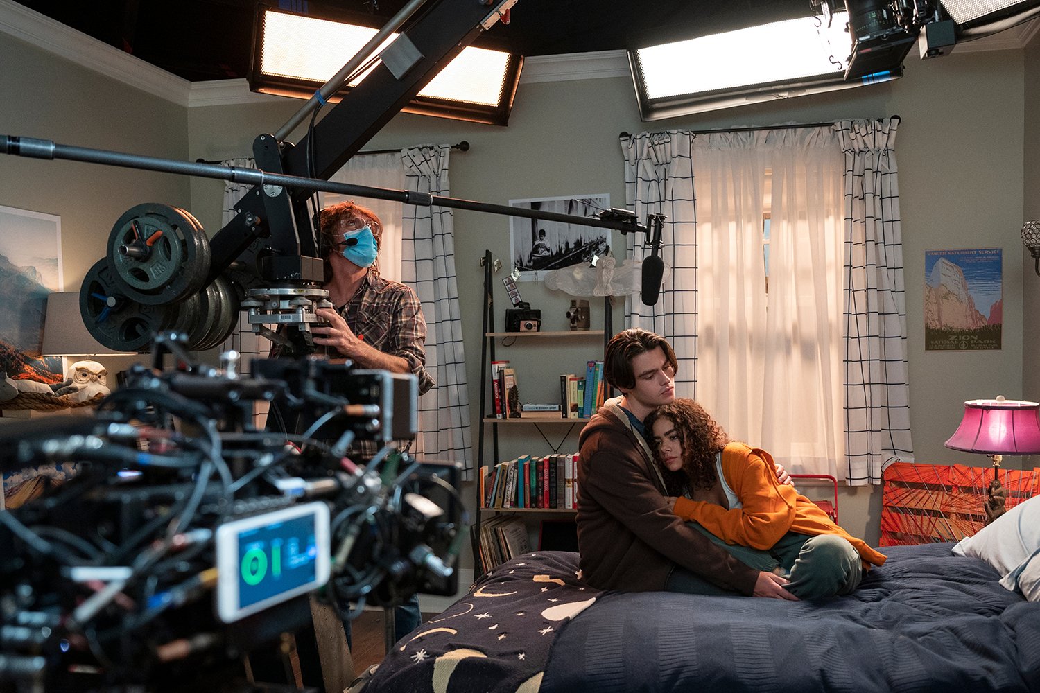 Ginny & Georgia behind-the-scenes photo shows cameras pointed at Felix Mallard and Antonia Gentry snuggling on a bed