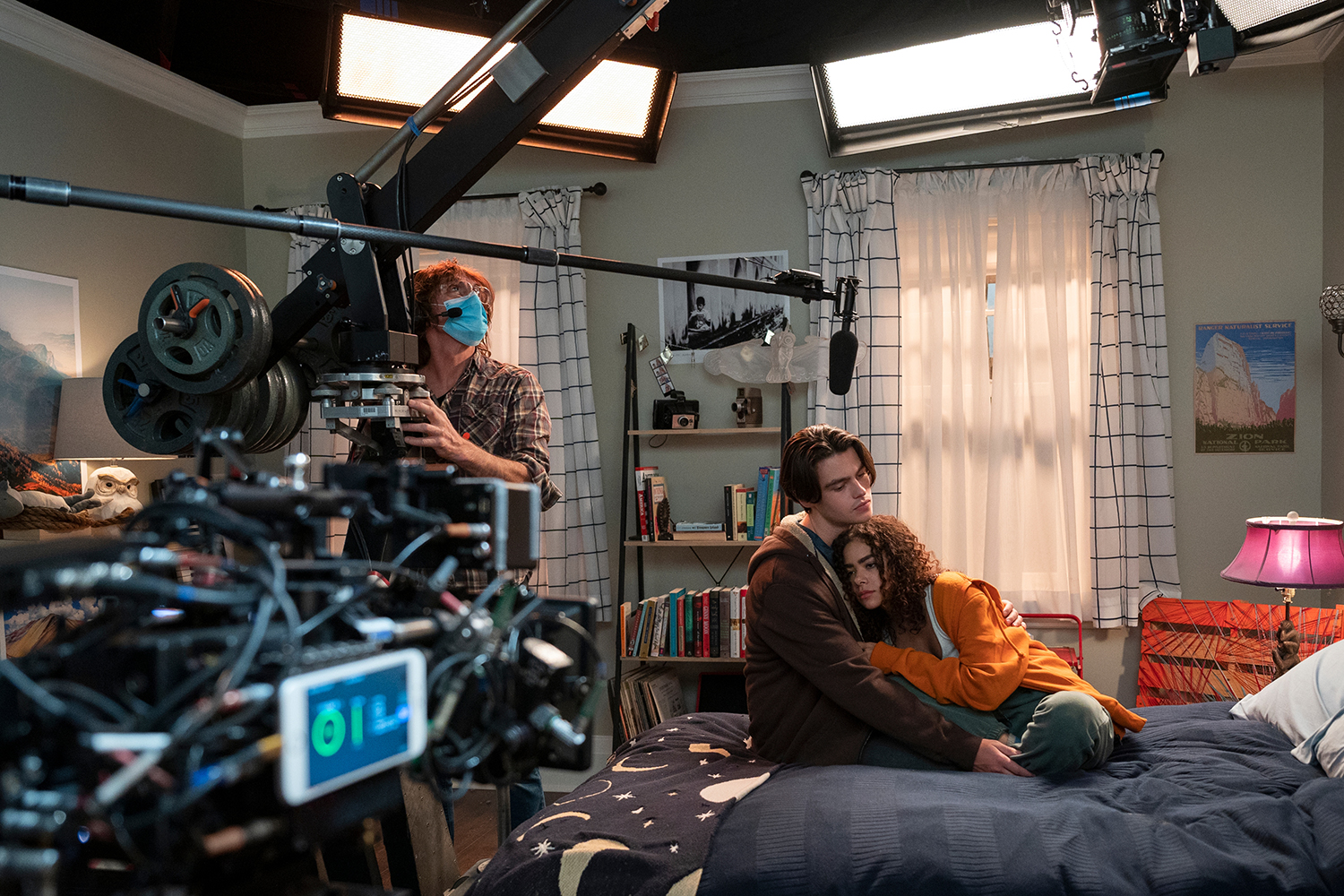 Ginny & Georgia behind-the-scenes photo shows cameras pointed at Felix Mallard and Antonia Gentry snuggling on a bed