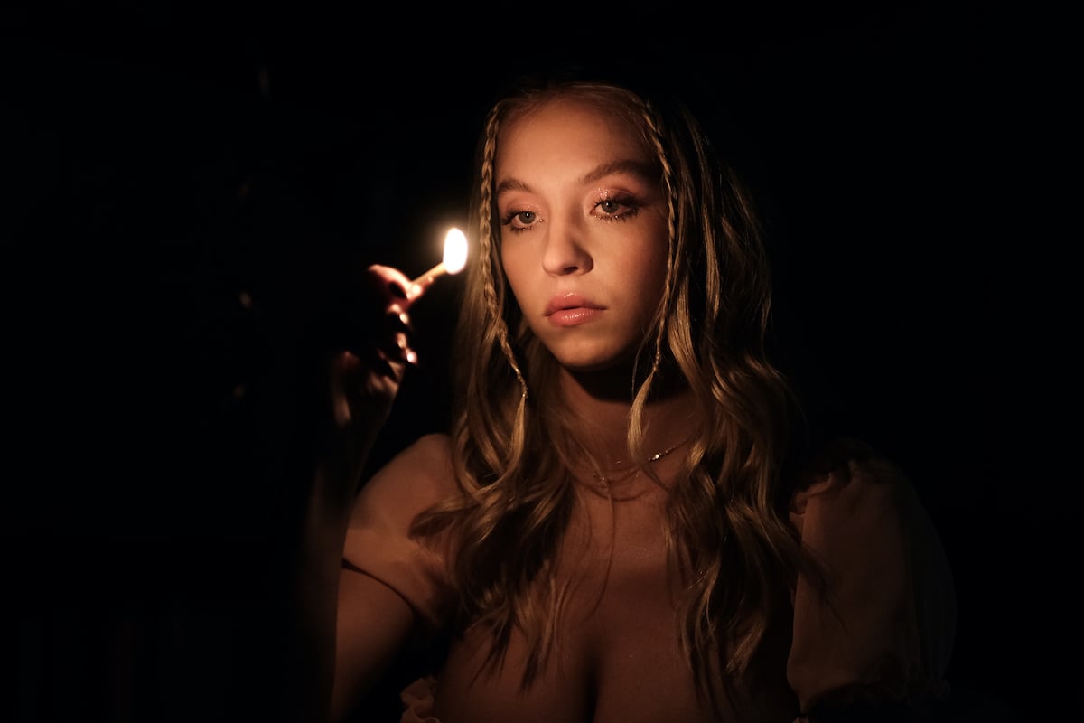ice rolling enthusiast Sydney Sweeney as Cassie Howard on Euphoria with a lit match in front of her face