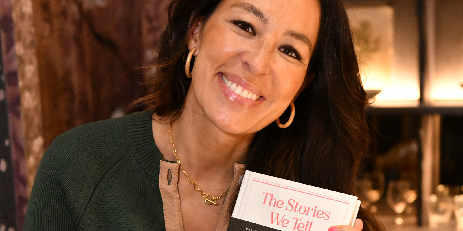 Joanna Gaines holds a copy of her book 'The Stories We Tell.'