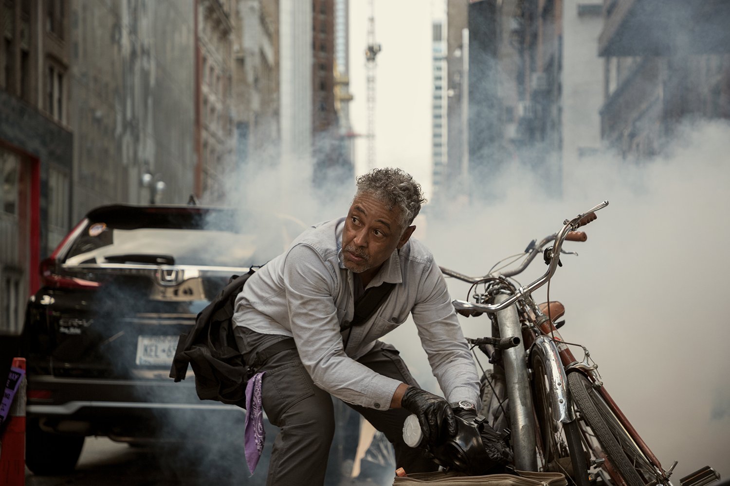 Giancarlo Esposito as Leo Pap locking a bicycle in Kaleidoscope, which is loosely based on a true story.
