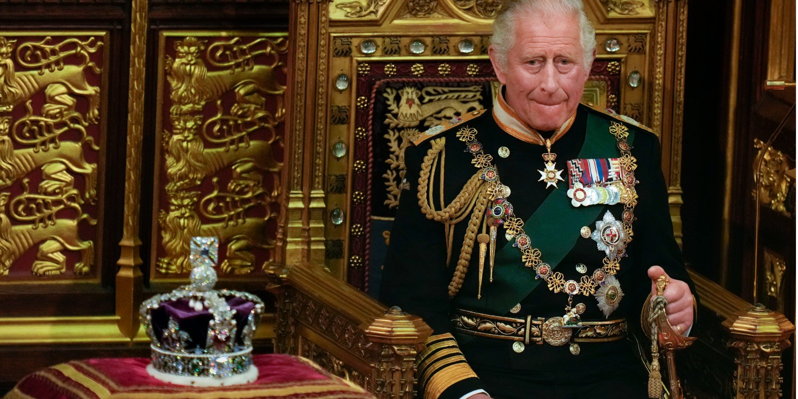 King Charles III is seated next to the St. Edwards Crown which will be work at his May 2023 coronation.