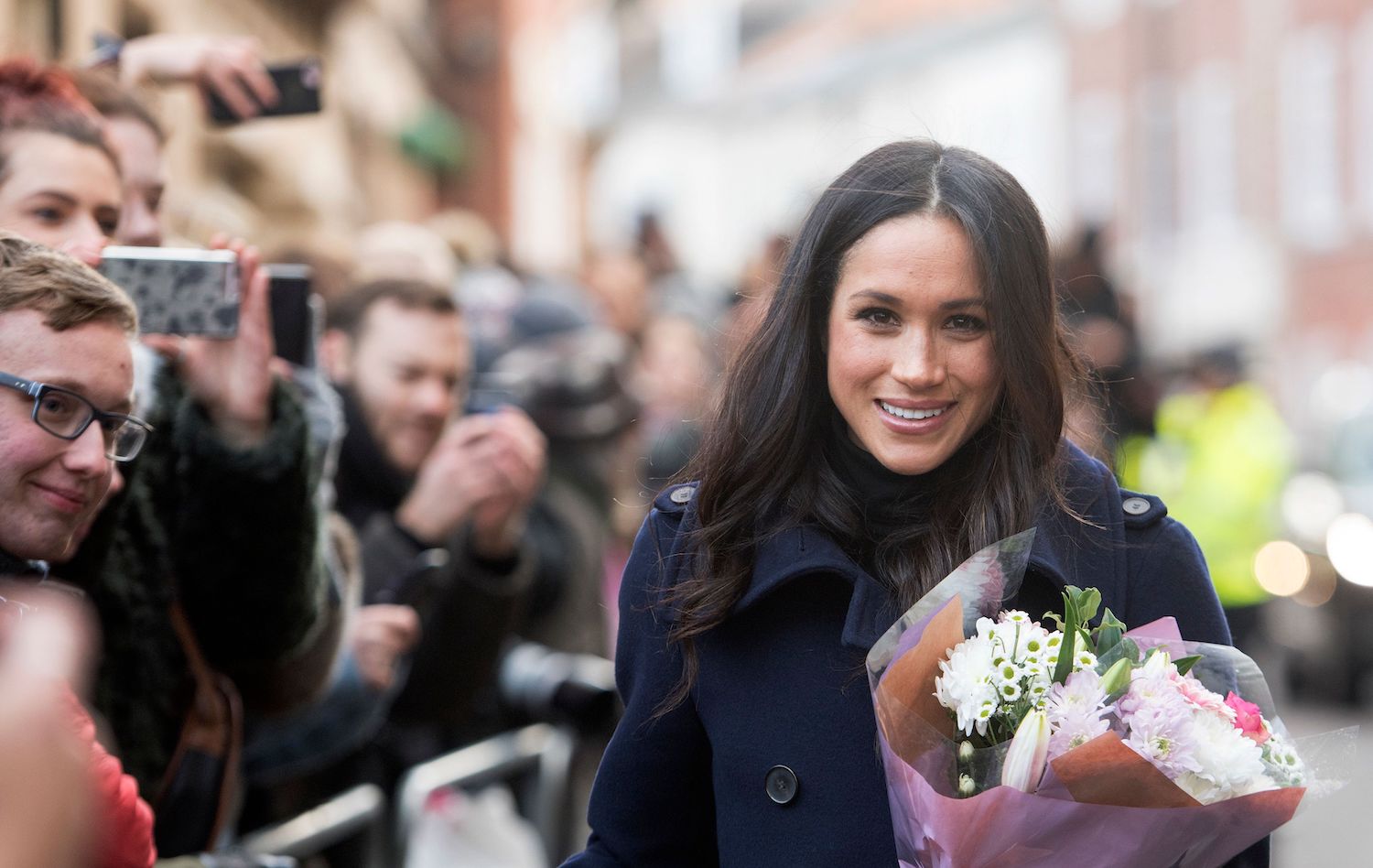 Meghan Markle smiles at a walkabout in Nottingham with Prince Harry