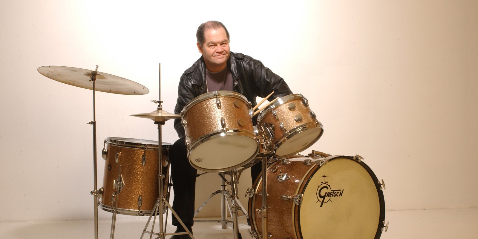 Micky Dolenz sits behind a drum set in a photograph taken in 2004.