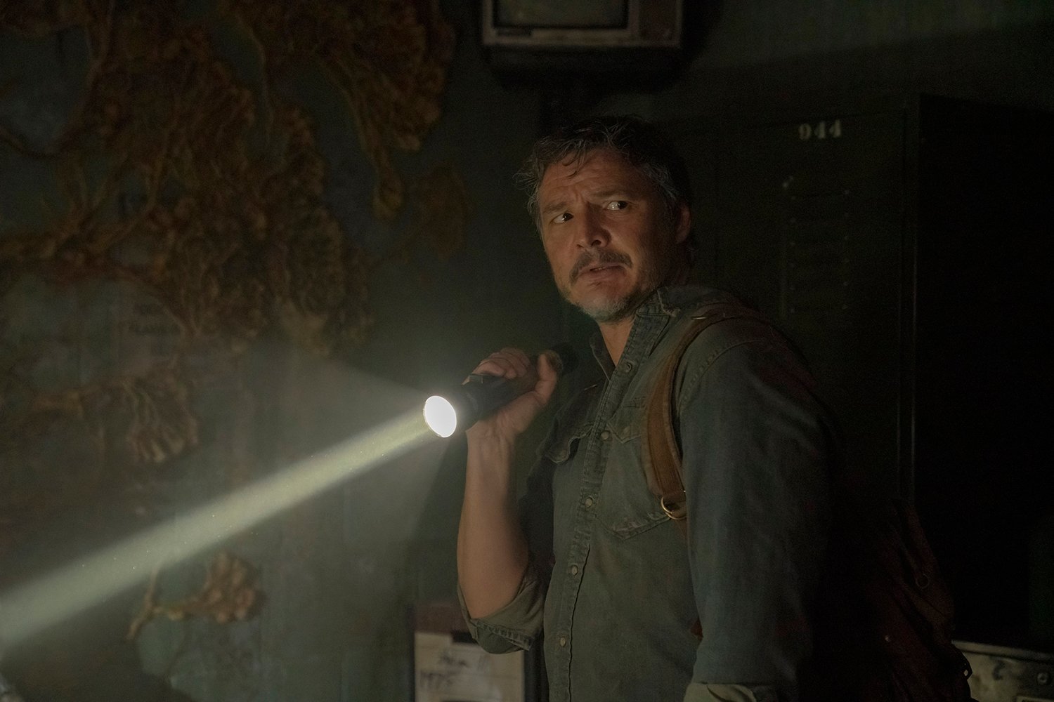 The Last of Us Episode 1: Pedro Pascal as Joel holding a flashlight