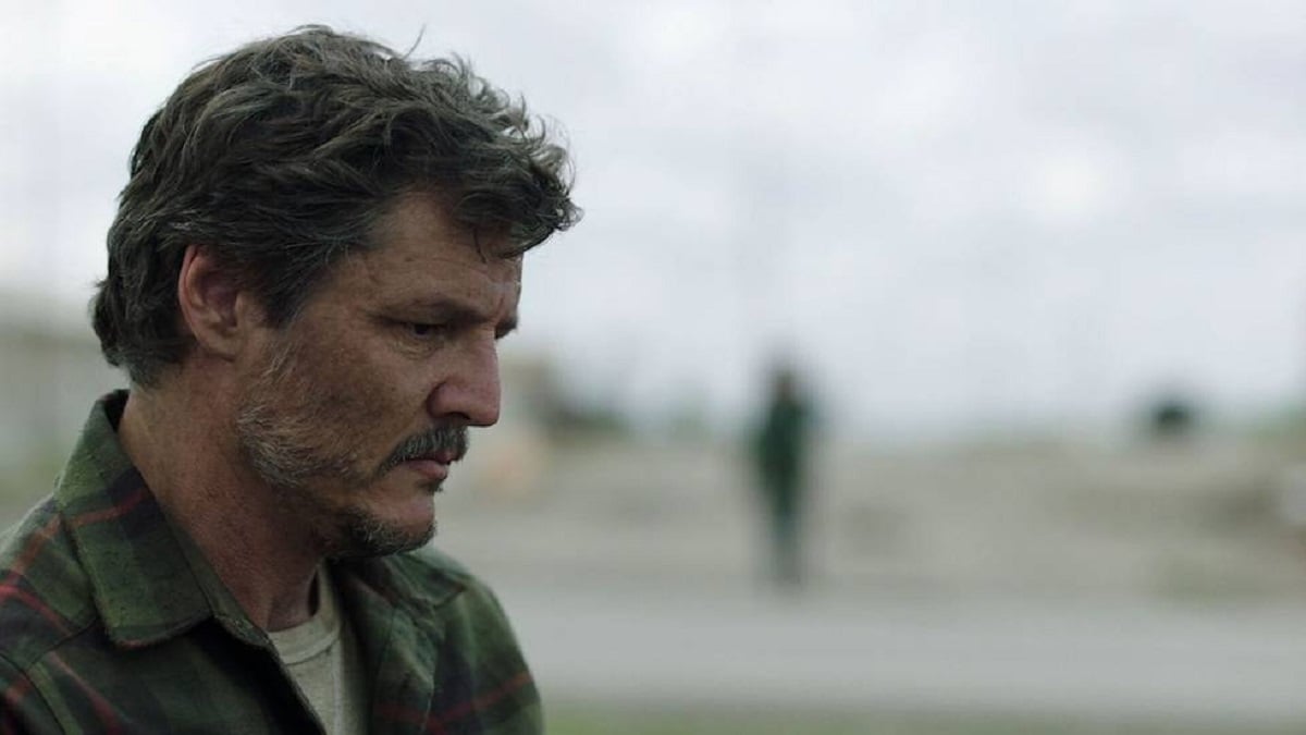 Pedro Pascal wearing a green shirt and looking down in a scene from ‘The Last of Us.’