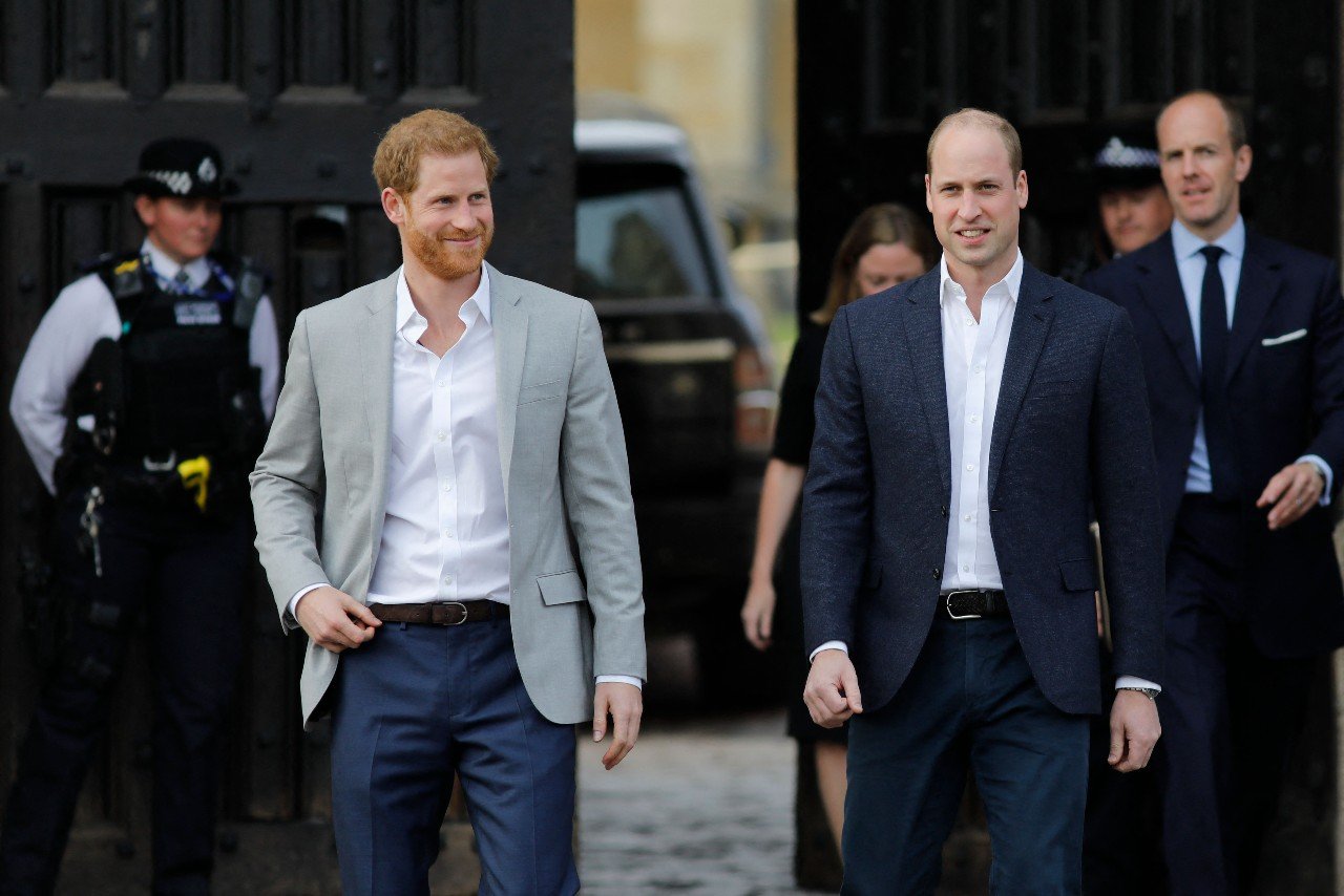 Prince Harry and Prince William walk together.
