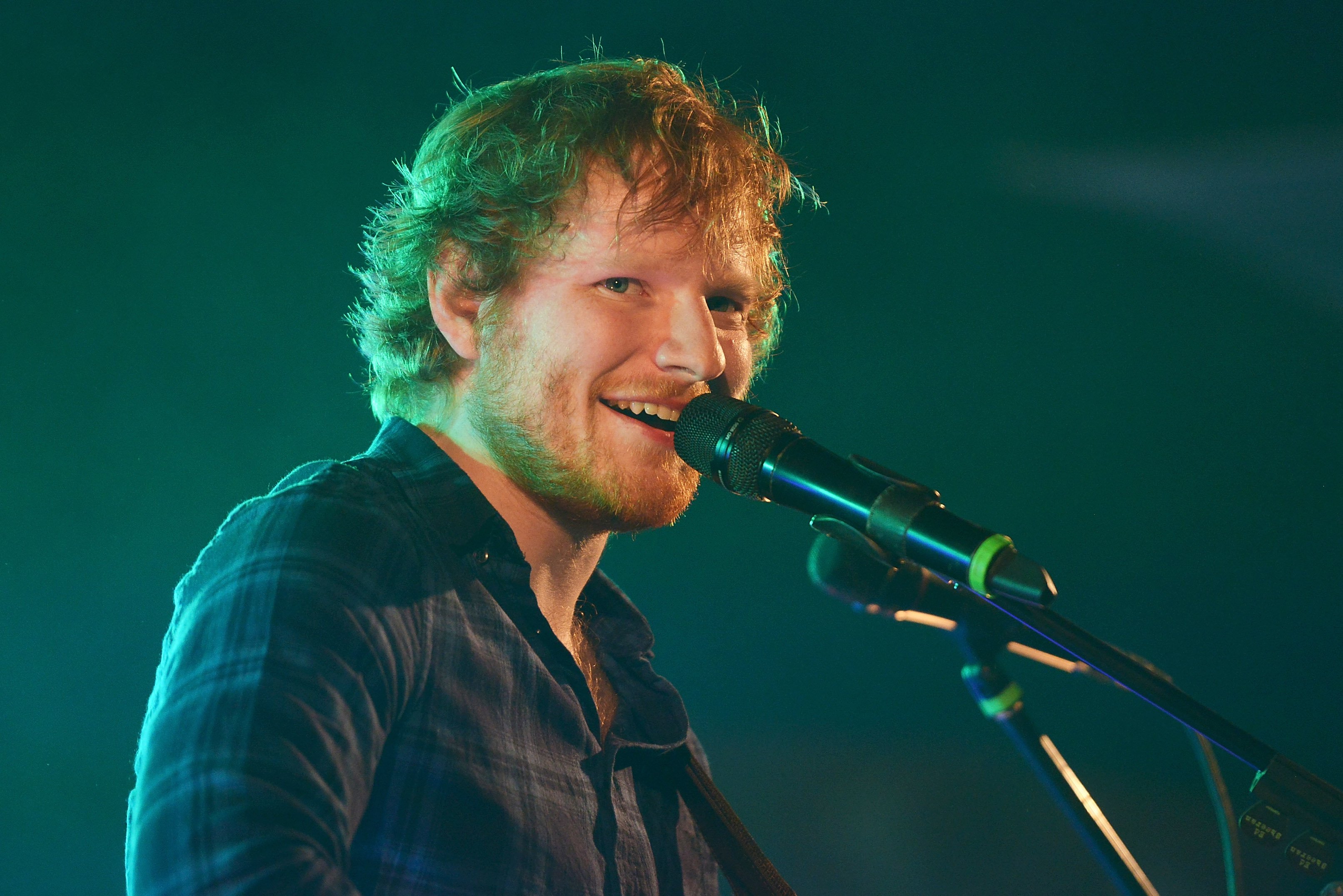 Ed Sheeran with a microphone during his "Photograph" era