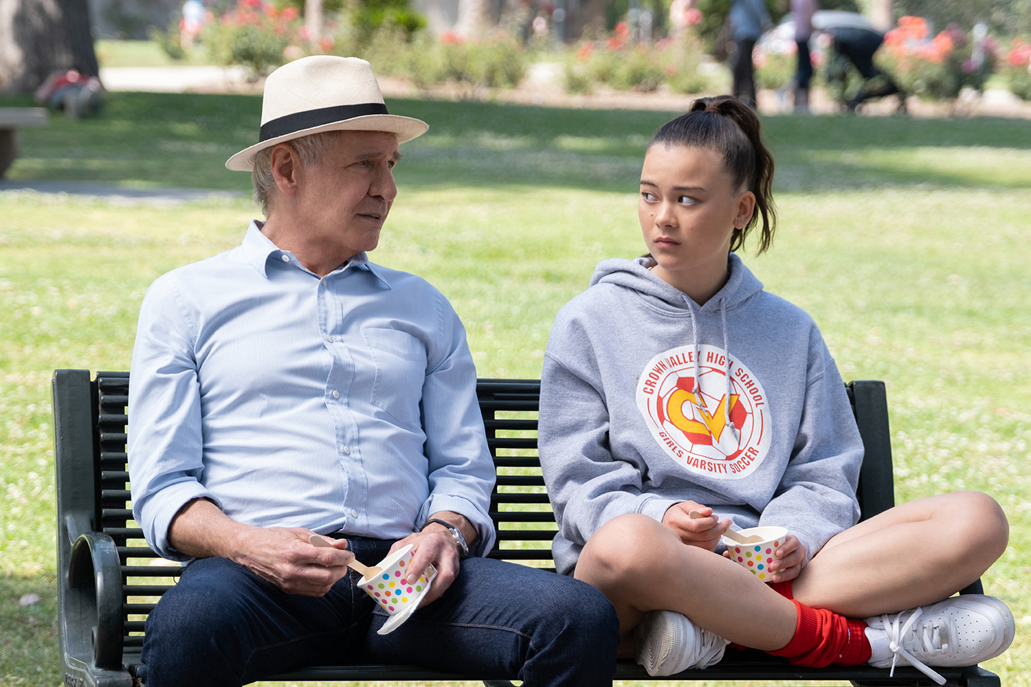 Shrinking: Harrison Ford as Paul and Lukita Maxwell as Alice sitting on a bench together and looking at each other