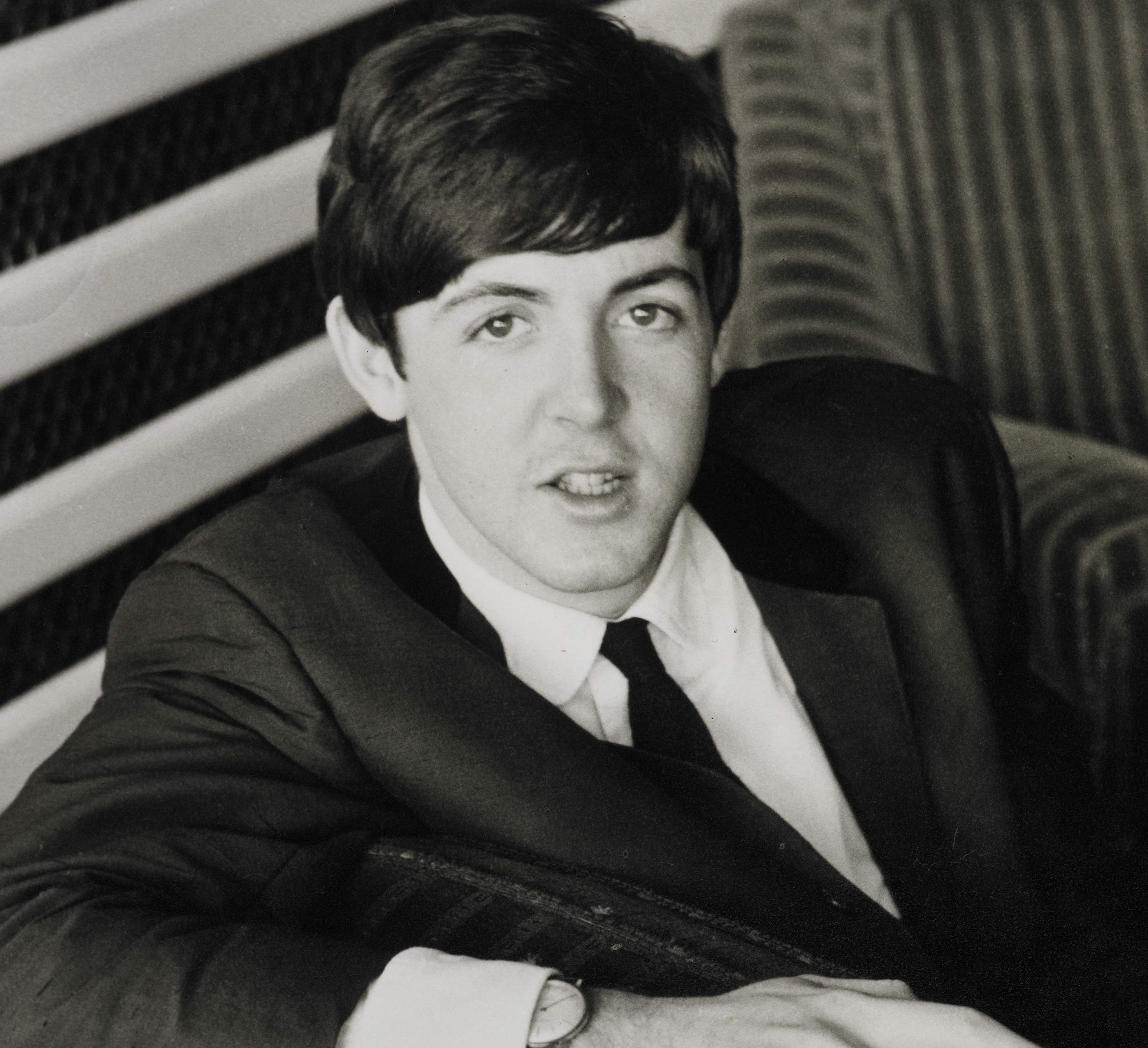 Paul McCartney in a suit during The Beatles' "Can't Buy Me Love" era
