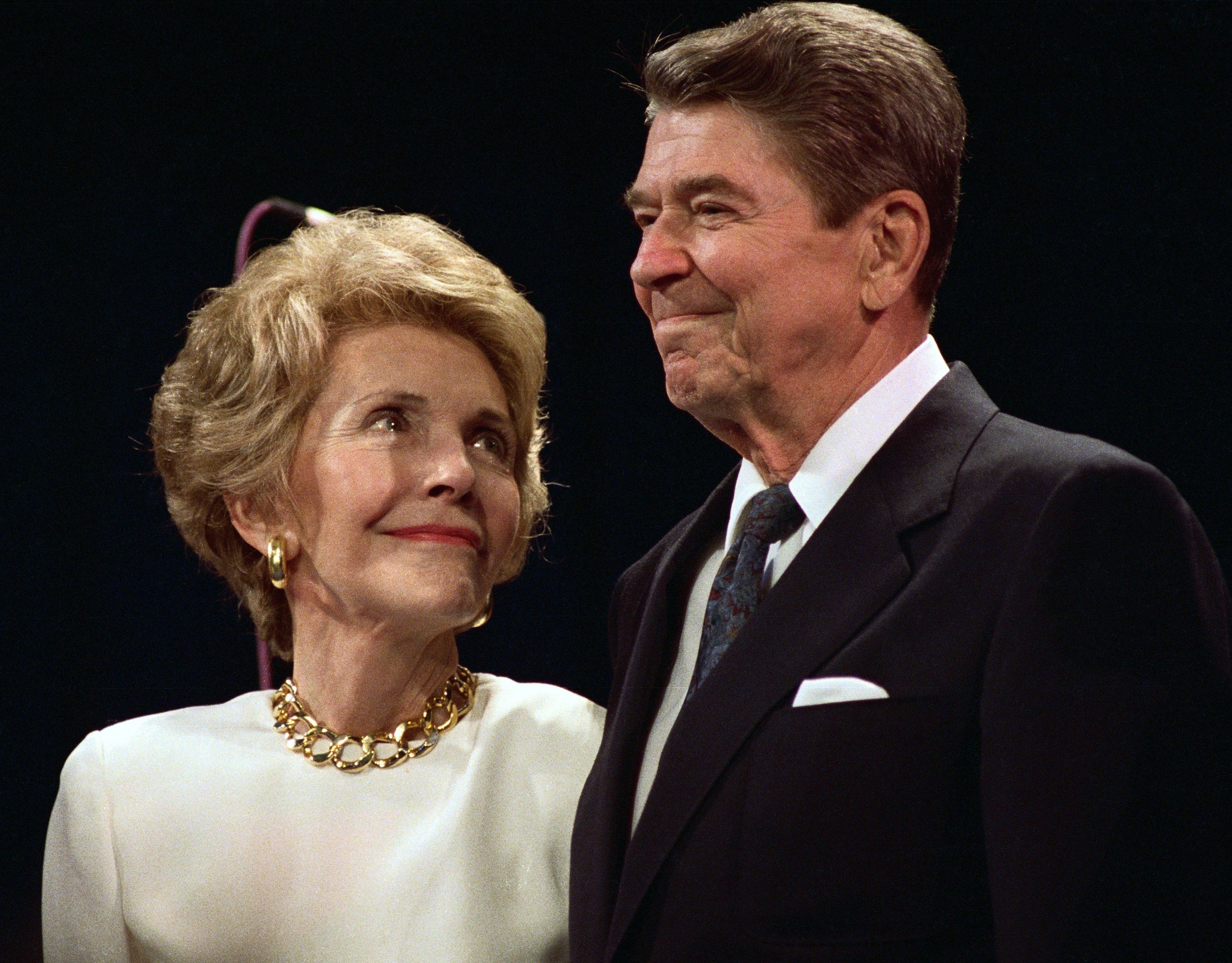 Nancy Reagan and Ronald Reagan with a black background