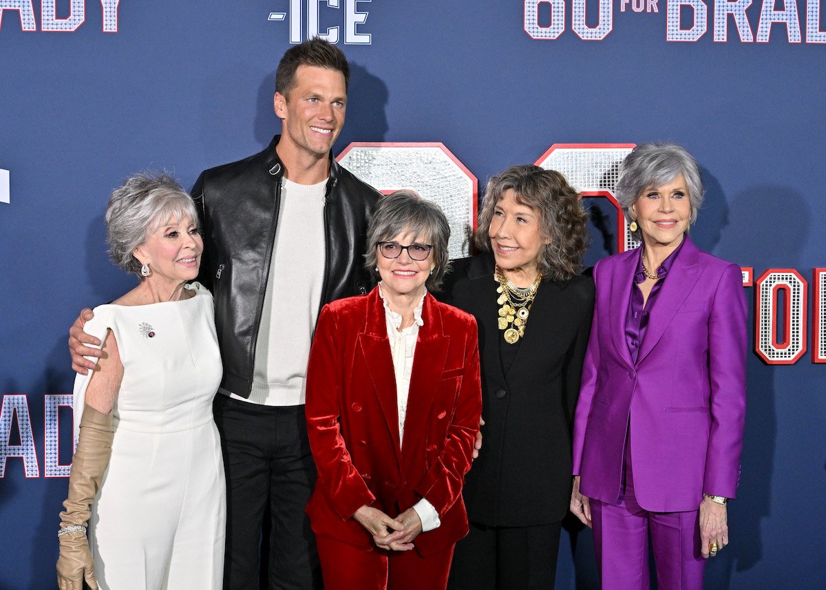 (L-R) Rita Moreno, Tom Brady, Sally Field, Lily Tomlin, and Jane Fonda smile at the premiere of 80 For Brady