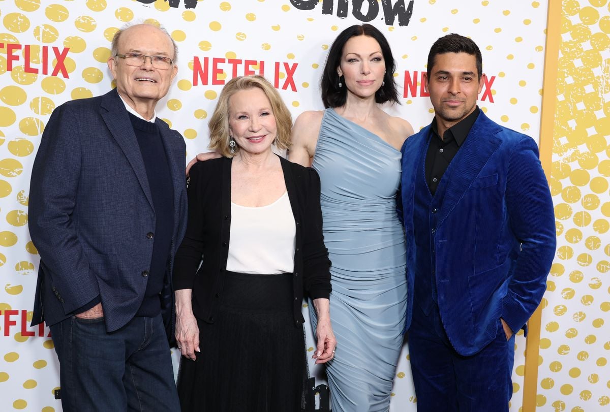 Kurtwood Smith, Debra Jo Rupp, Laura Prepon, and Wilmer Valderrama pose in front of a yellow backdrop with the Netflix logo.