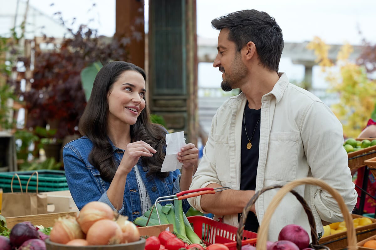 Rhiannon Fish and Tyler Hynes smiling at each other in 'A Picture of Her,' on the Hallmark Channel schedule in March 2023.