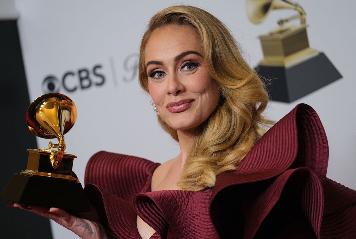 Adele poses with a Grammy award