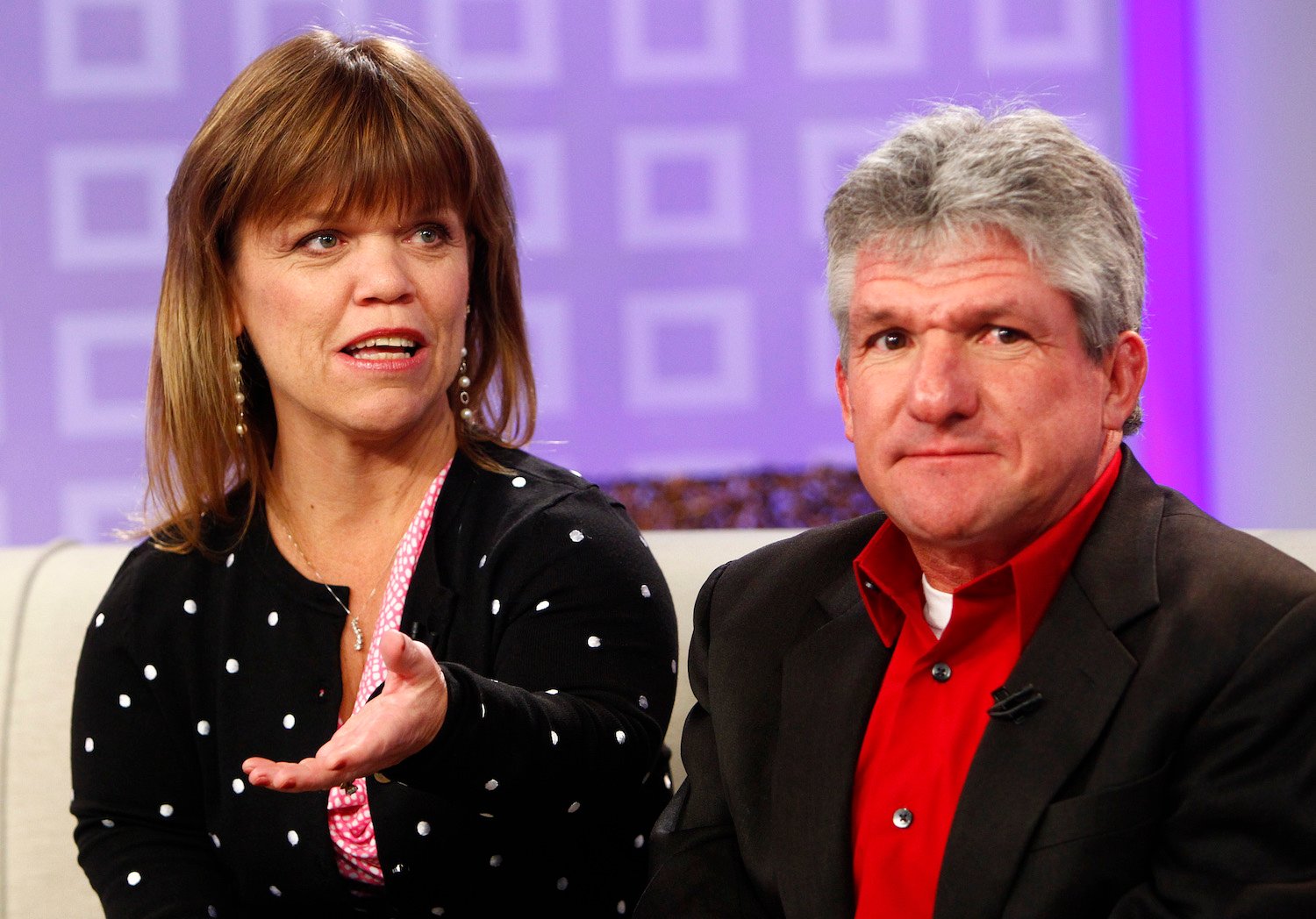 Amy Roloff and Matt Roloff from 'Little People, Big World' sitting during an interview against a purple background