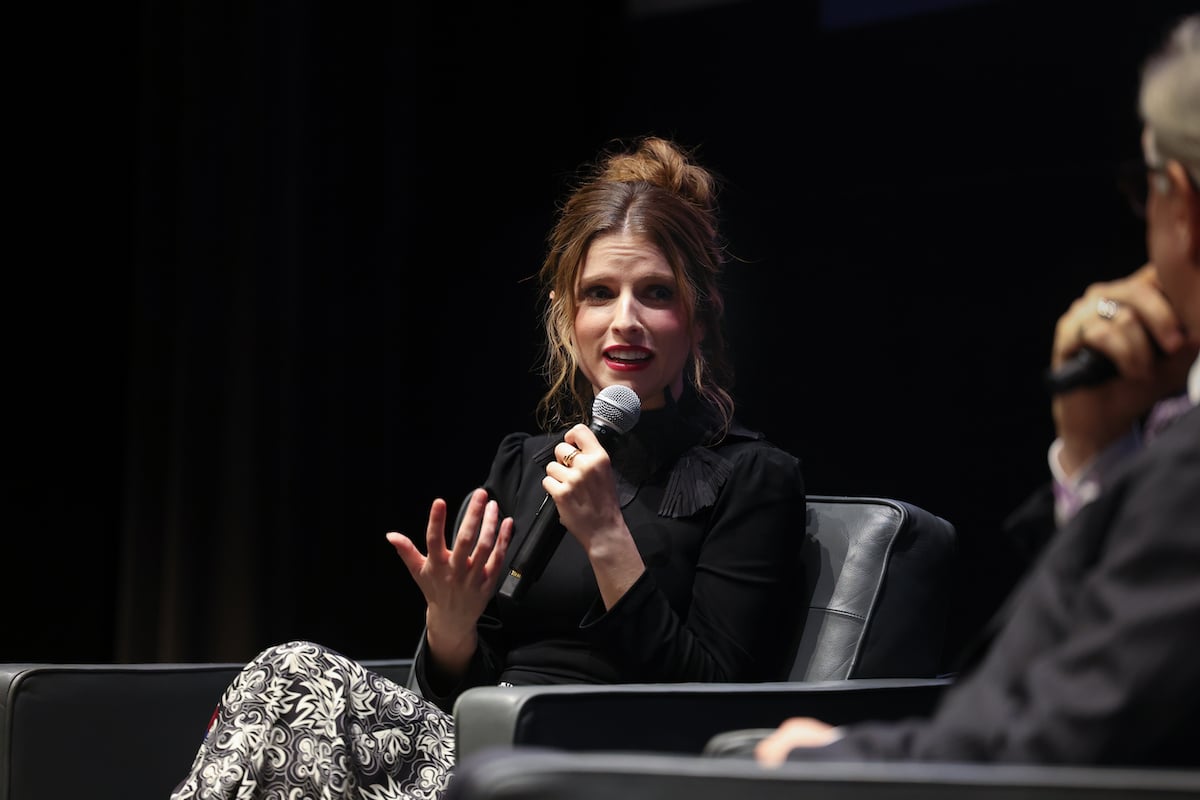 Anna Kendrick speaks into a microphone.