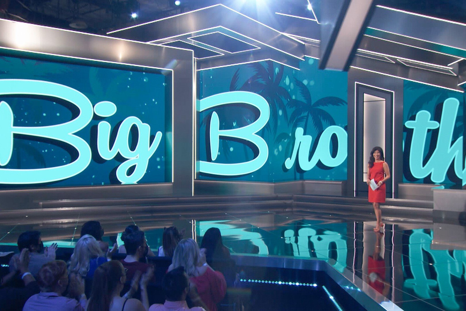 Julie Chen Moonves stands on the 'Big Brother' stage in a red dress. Casting for 'Big Brother' Season 25 begins on Monday, Feb. 13.