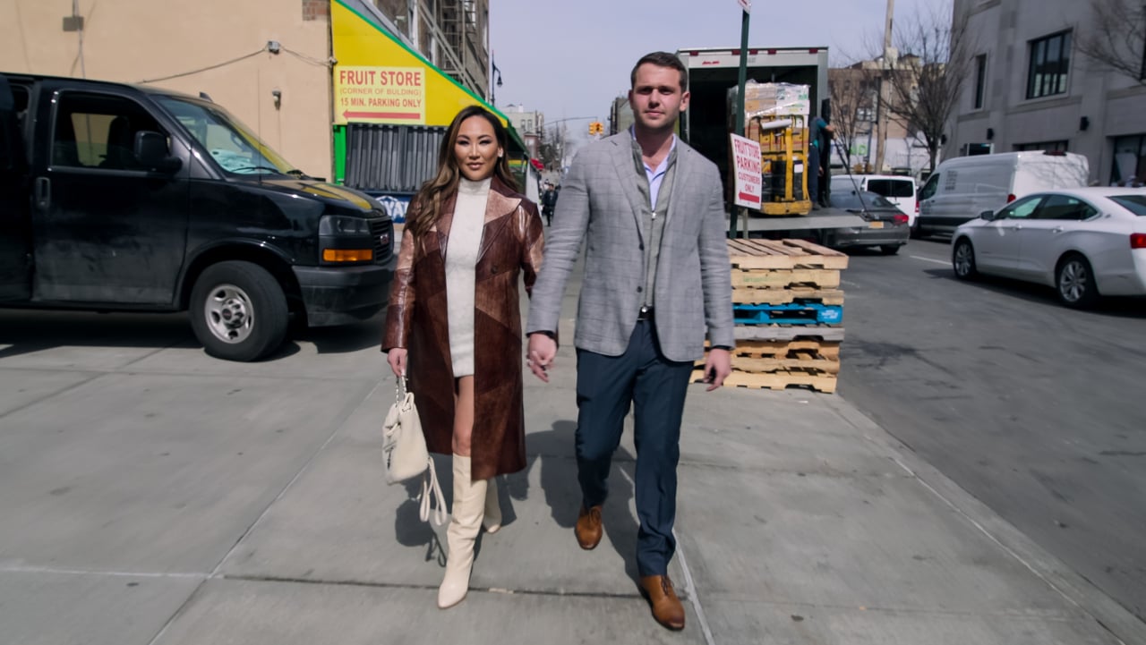 Dorothy Wang and Ari Kourkoumelis holding hands during an episode of 'Bling Empire: New York'