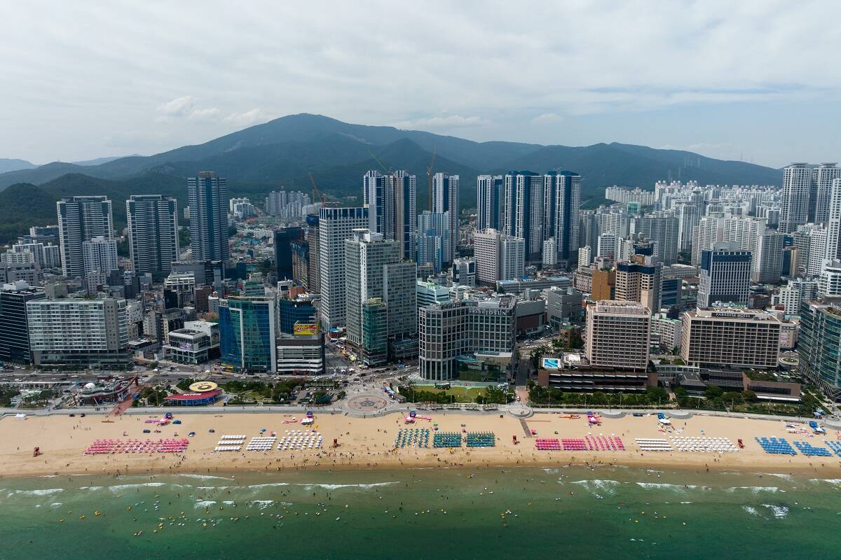 The Haeundae beach in front of commercial and residential buildings in the Haeundae district in Busan, South Korea. Lane Kim traveled to the tourist attraction in season 1 of 'Gilmore Girls'