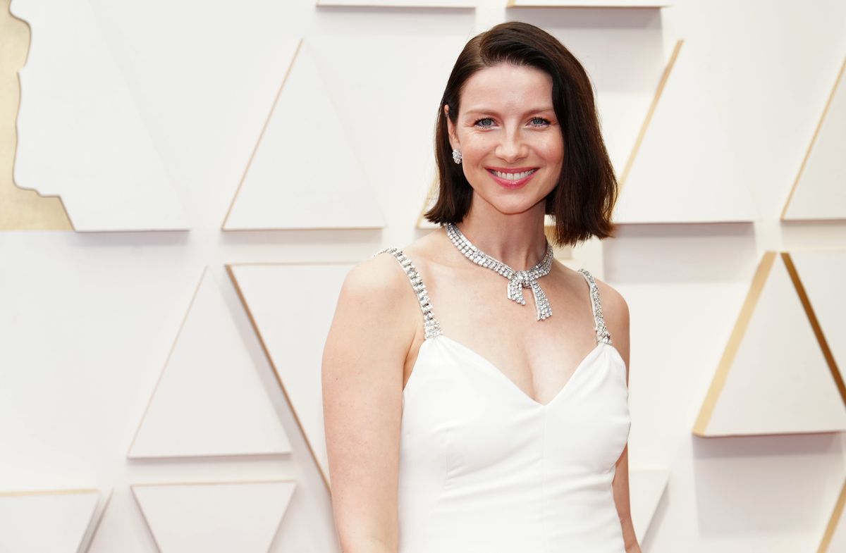 Caitriona Balfe poses in front of a white backdrop.
